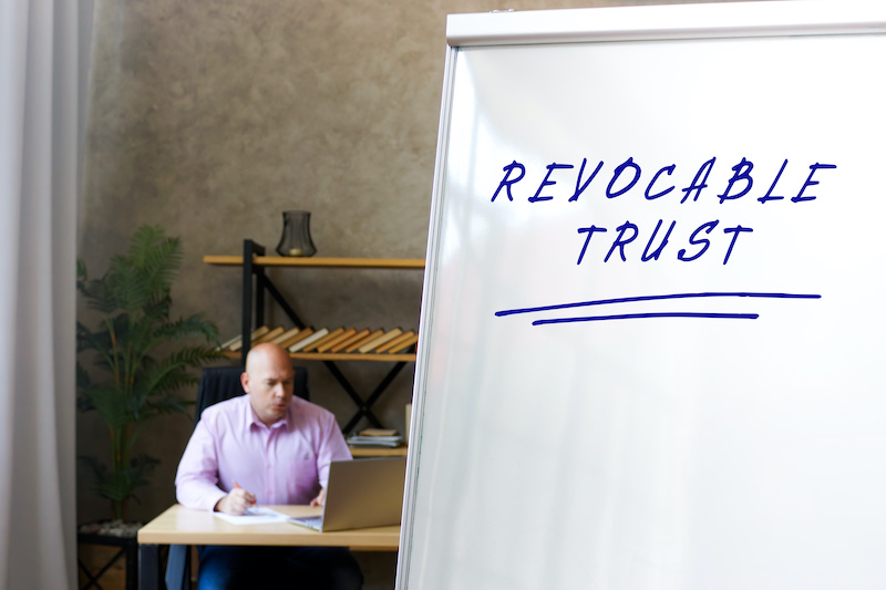 Conceptual photo about REVOCABLE TRUST with handwritten text.