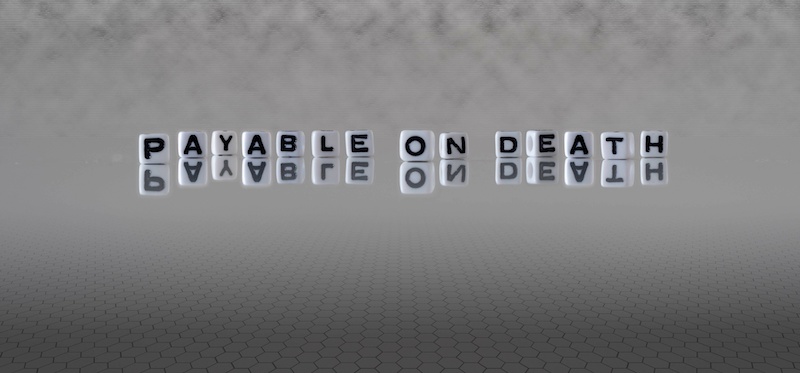 payable on death word or concept represented by black and white letter cubes on a grey horizon background stretching to infinity