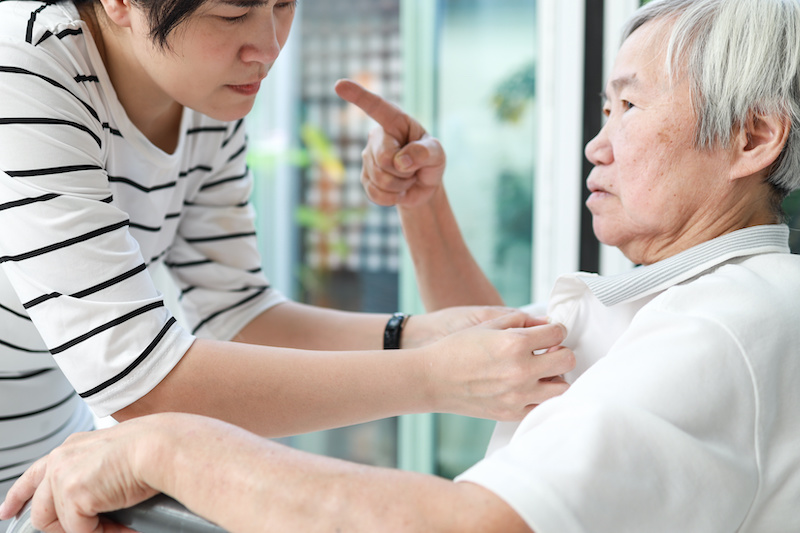 Angry asian senior grandmother scolding woman,Aggressive old elderly people shouting pointing finger at frightened female caregiver,dissatisfaction irritated,violence aggression,mental health concept