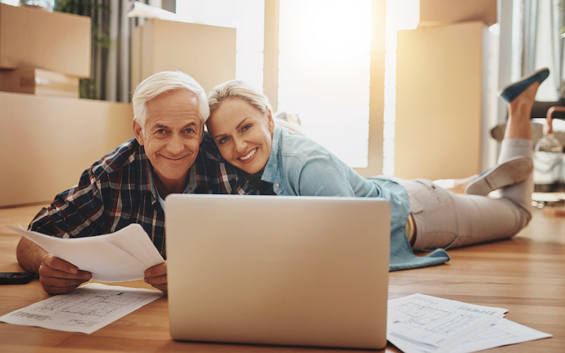 Portrait, new home and old couple with laptop, documents for renovation and planning with research. Face, people and man with woman on floor, pc and paperwork for mortgage, real estate and property.