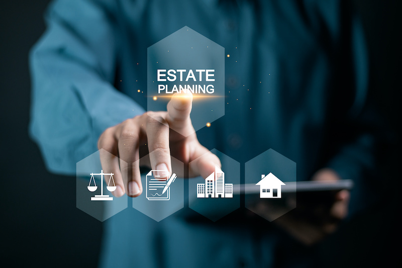 Estate Planning concept. Planning for the transfer of assets and Inheritance tax. Businessman touching estate planning icons on virtual screen.