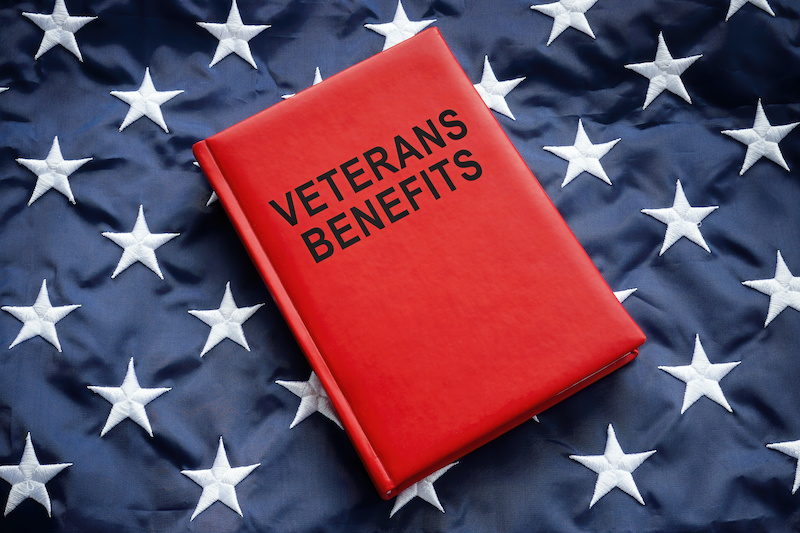 A Book veterans benefits on a big flag.