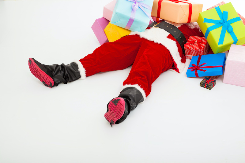 santa claus too tired to lie on floor with many gift boxes over white background