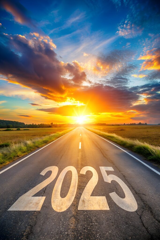 New year 2025 concept. Text 2025 written on the road in the middle of asphalt road with at sunset. Concept of planning, goal, challenge, new year resolution.