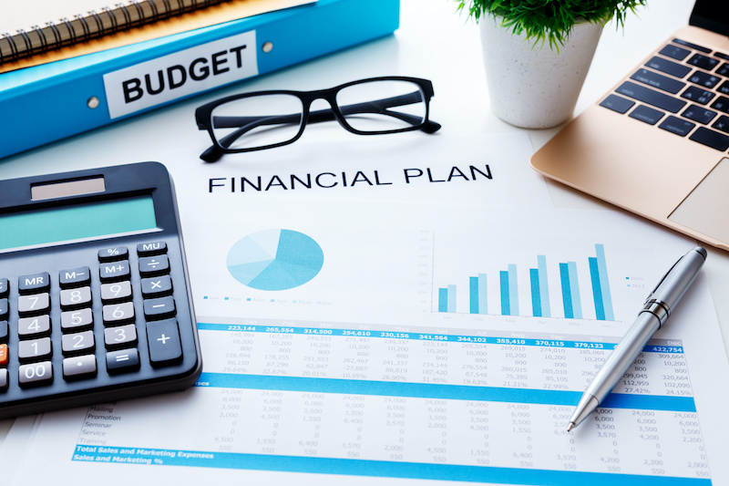 Financial and budget planning concept with calculator laptop and finacial report