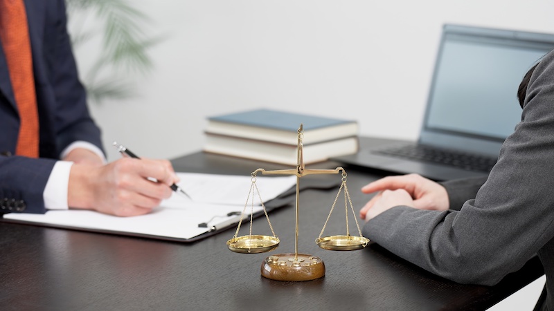 The hands of a lawyer receiving consultation on a problem