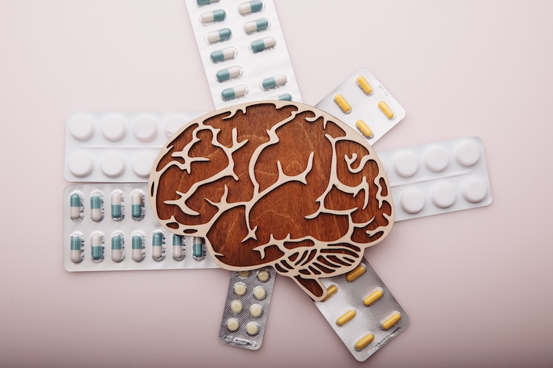 Brain and pills isolated on pink background. Dementia concept. Top view.