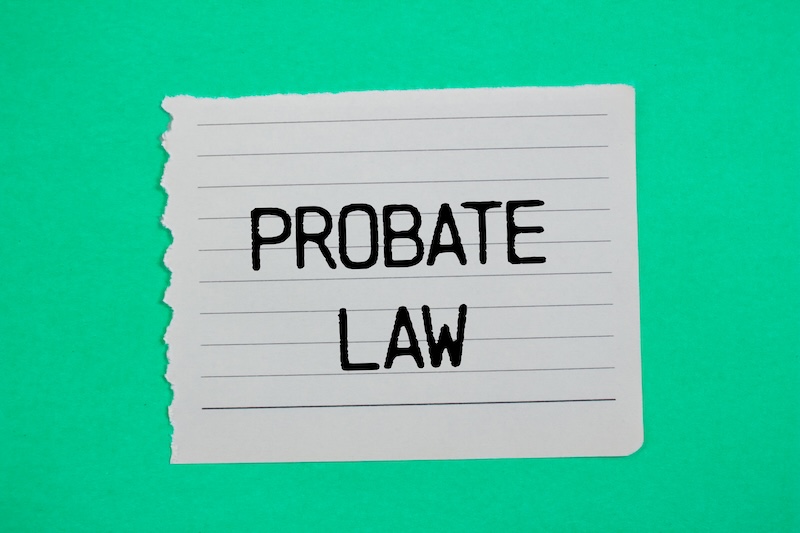 Probate law message written on ripped torn paper piece with green background. Conceptual probate law symbol. Copy space.