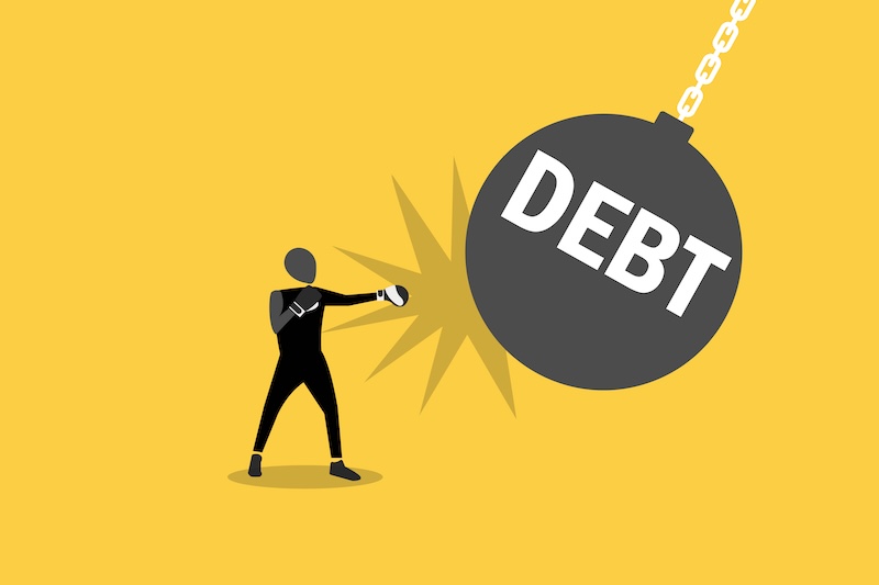 Businessman wearing boxing gloves punching with creditor or huge boom debt