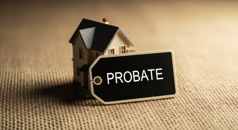 A miniature house with a tag that reads "PROBATE".