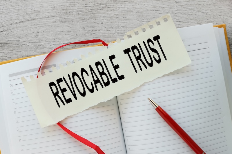 Irrevocable trust text on a torn page on a notepad