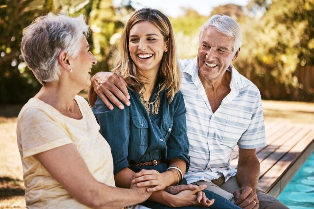 Family, senior parents and woman by pool holding with care, love and hug bonding outdoor. Smile, happy person and people in retirement with adult daughter together with bokeh in nature in summer. SSUCv3H4sIAAAAAAAAA22S227sIAxF/4XneSAZMprOr1RHR+aSCSrgCJy2aTX/XgORei5929vC28tOPoWG4o24fQofwlYoA3lM4iZPIrtkXW7yNZ8vsilnPWH2EJrTQGZJEJ24ibIg0u/rMFzUJB4nUQhoK65wNjsD5O7c2Pz3UC5zq+DXm66CX8of64/KExy0wGfh5uFpmmZpFL9RyszSKjOe2ZzHixqV0VfNRkqltJzsdRK/TuLljVyOBxBs1mOXa/bGp3s3SEtdujHzPTBWnLJsxL1szUv1/QoJydG+8vIDg86G4dIWdW0XwzheBzmpRl4flr6P5Tscm7X7LJ5D894HtnxvD8JtDQiWKqQAi9od4+uwv3i4YLODWMjHDgMB4t6U252LTUUstC5IWJrdYY/eZGxmxWSnpgwG3LLG916HVM8ReV/oc9yKxf+Zo/29YbRSjwh+tQ5CvUPN8O8EB0H9t/grRpeodxtI/3SX/0sfiAl6mPWlYHjtWw7jOc+sHo8voE3K58cCAAA=