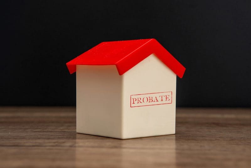 Toy house stamped with the word Probate