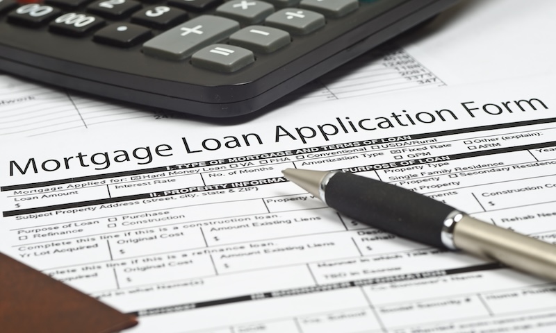 mortgage loan application form, the  pen and a calculator.